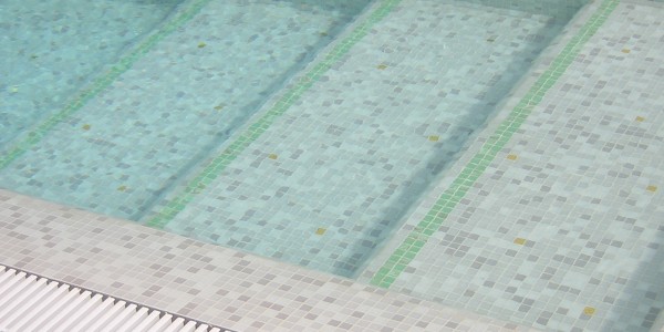 Piscina interrata con mosaico e scale.